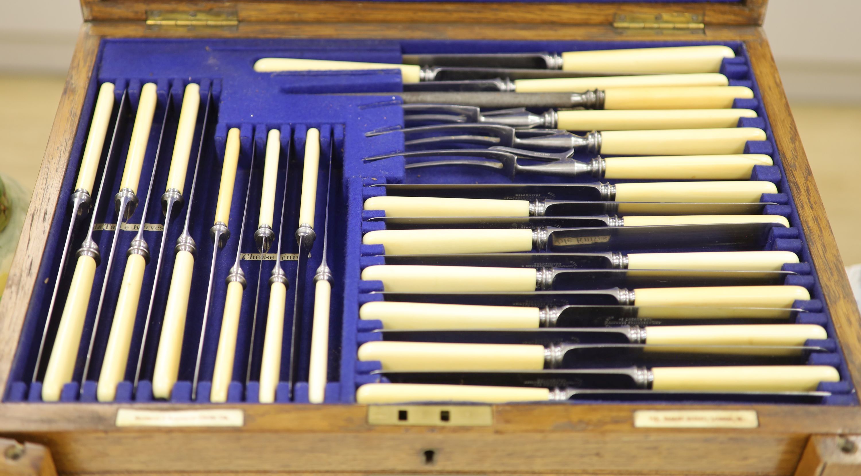 An oak cutlery box containing plated cutlery, 29 x 48cm